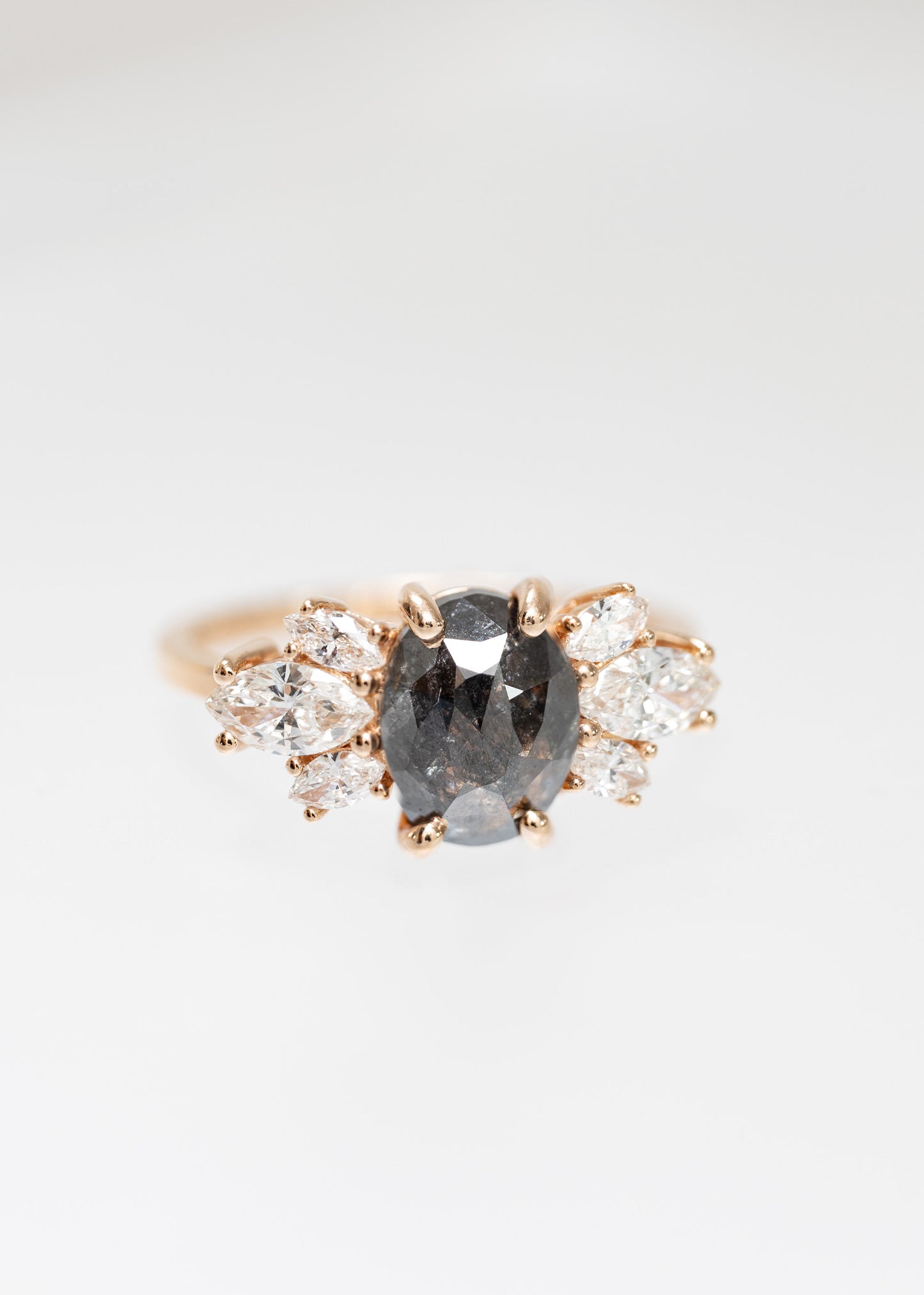 Oval salt and pepper diamond cluster engagement ring in 14K rose gold with marquise diamond accents