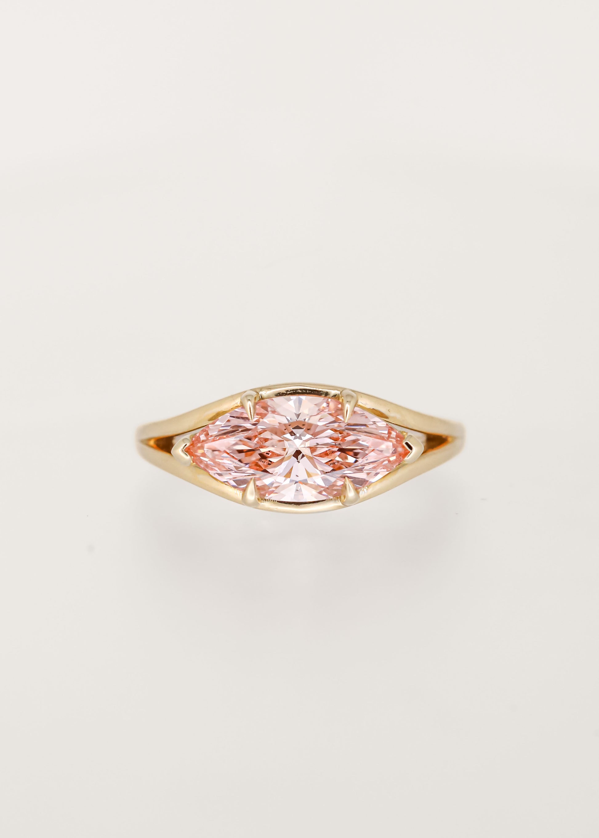 Unique east west marquise cut pink lab grown diamond engagement ring in 14K yellow gold with a split shoulder band