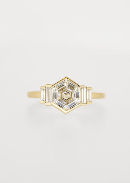 Bezel set hexagon lab grown diamond engagement ring in 14K yellow gold with graduated baguette accent stones
