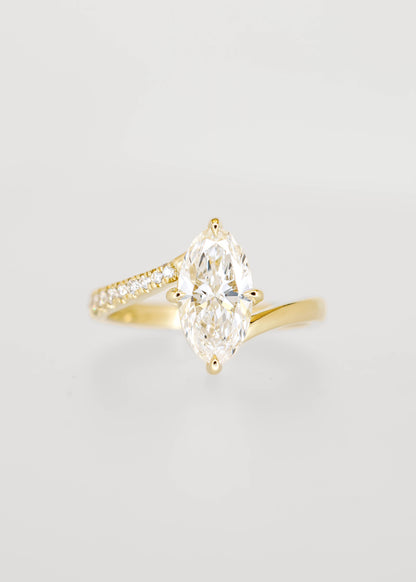 Moval cut lab grown diamond engagement ring in 14K yellow gold with an asymmetric bypass band and pavé accents