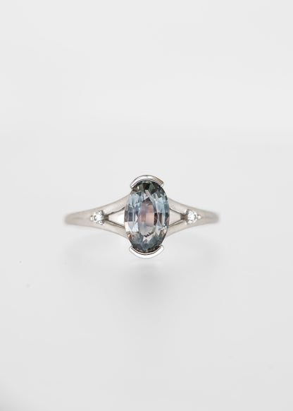 Moval cut grey blue sapphire engagement ring in 14K white gold with a split band and round diamond accents