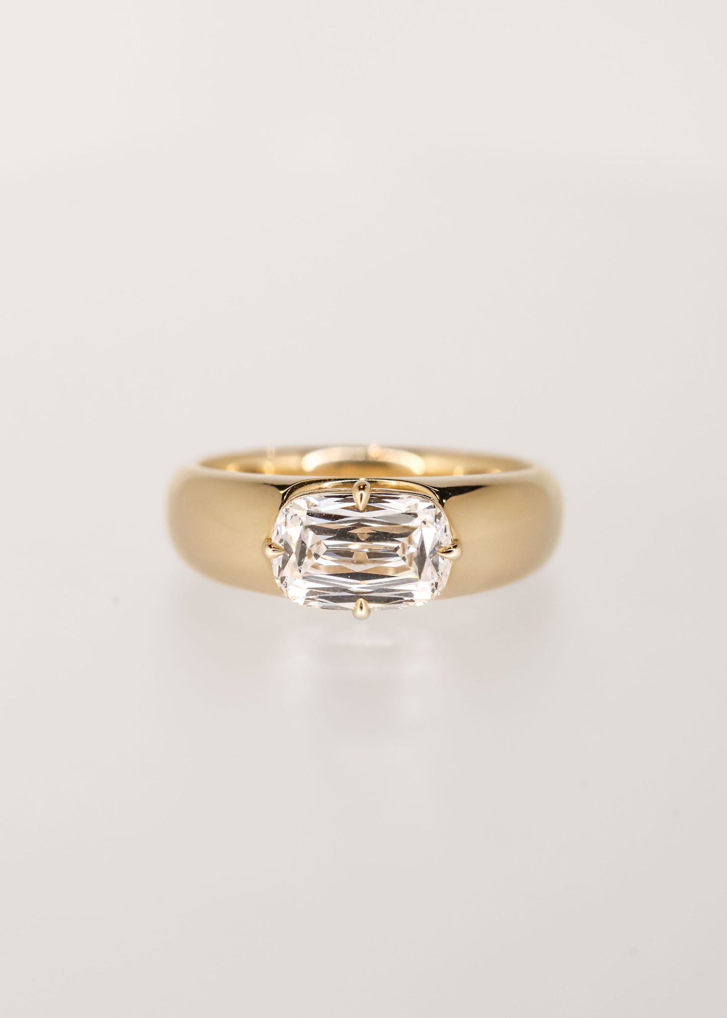 Gender neutral east west ashoka cut lab grown diamond engagement ring in 14K yellow gold with a chunky domed band and compass prongs