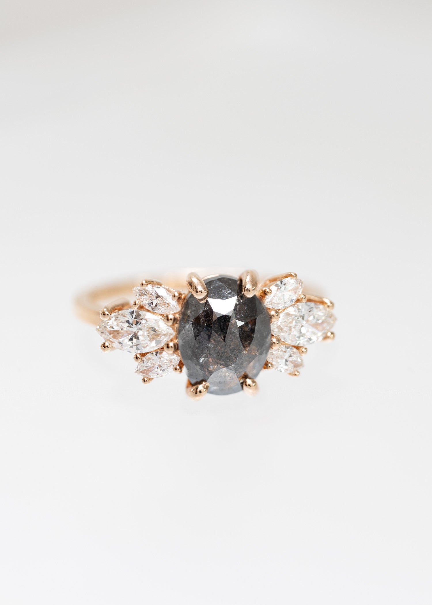 Oval salt and pepper diamond cluster engagement ring in 14K rose gold with marquise diamond accents