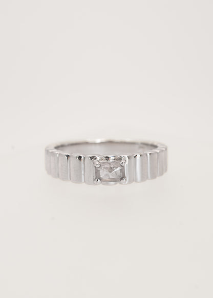 Gender neutral emerald cut salt and pepper diamond engagement ring in 14K white gold with a textured ribbed band and four prong setting
