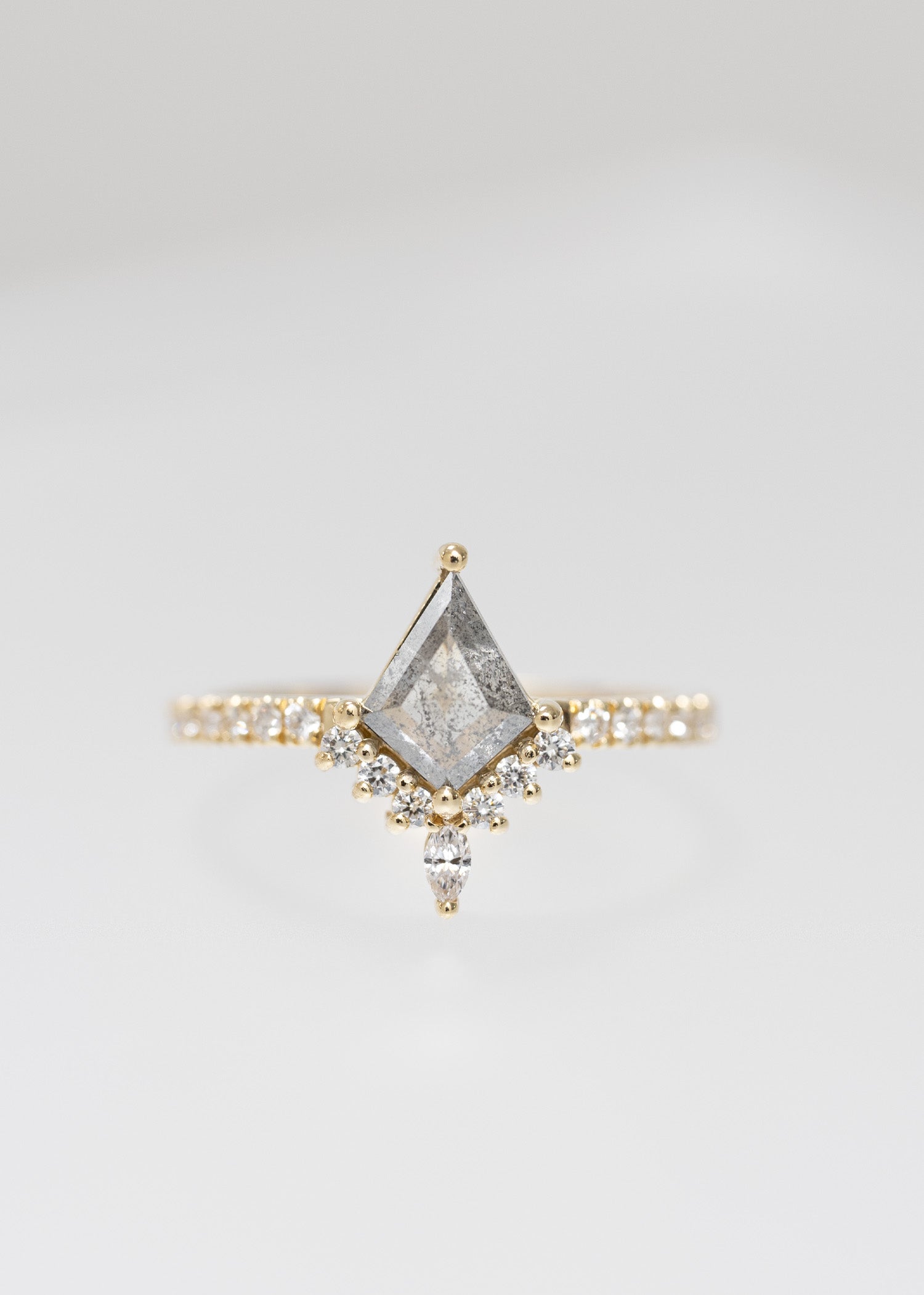 Kite cut salt and pepper diamond engagement ring in 14K yellow gold with a diamond accent crown, marquise accent, and pavé band
