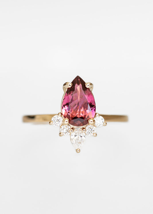 Pear cut pink tourmaline engagement ring in 14K yellow gold with a celestial diamond accent crown and pear accent