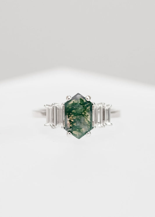 Elongated hexagon moss agate engagement ring in 14K white gold with graduated baguette accent stones