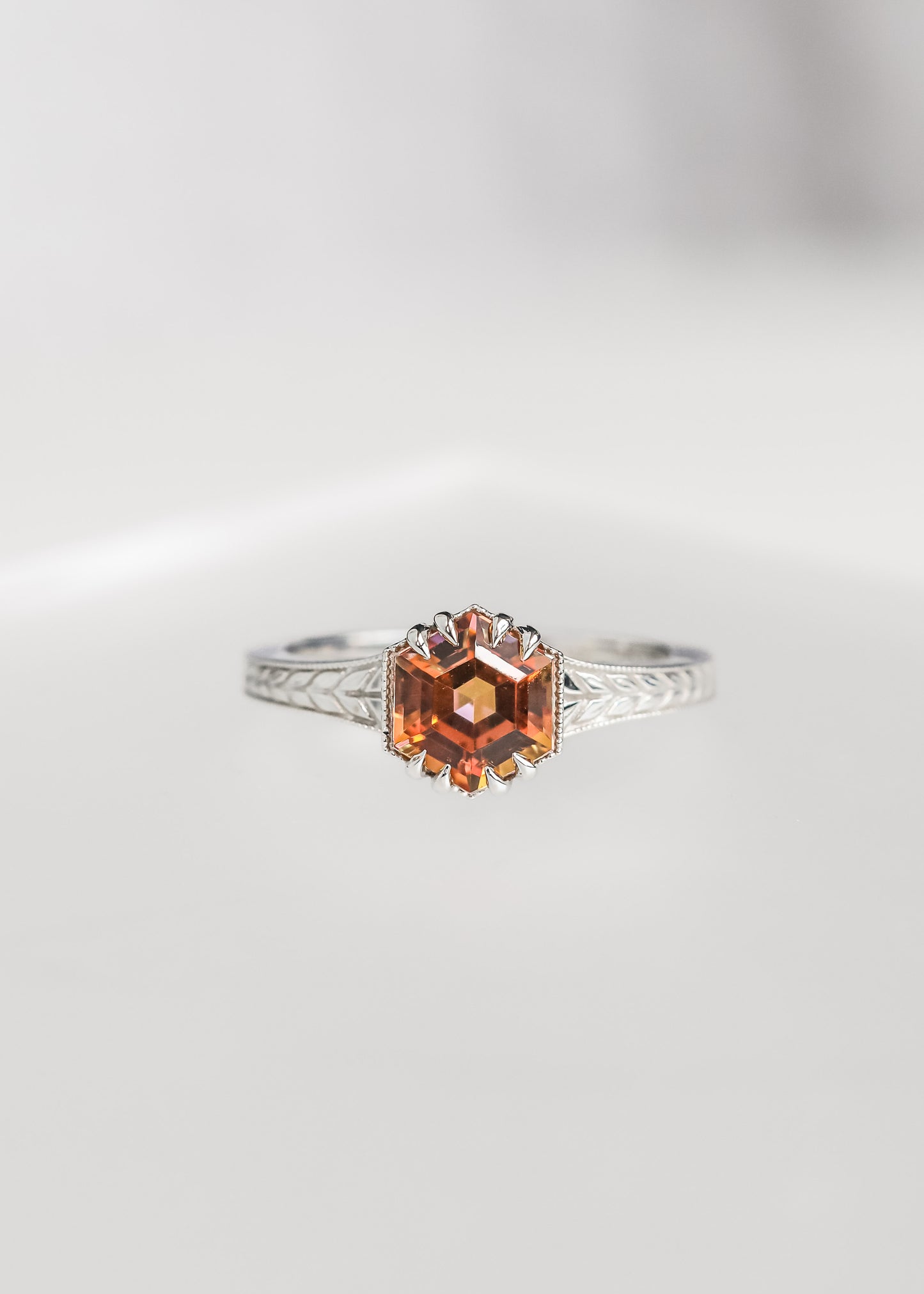 Hexagon cut mystic topaz engagement ring in 14K white gold with milgrain and an engraved wheat band