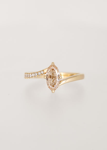 Step cut oval champagne diamond bypass engagement ring in 14K yellow gold with partial pavé and a north south setting