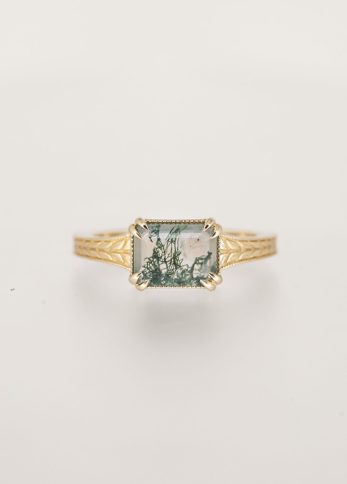 Gender neutral vintage east west emerald cut moss agate engagement ring in 14K yellow gold with milgrain and engraved wheat detailing